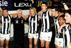 Collingwood coach Mick Malthouse makes a rare appearance in the post-victory huddle to sing the Magpies club song after the nail-biting win over Adelaide.